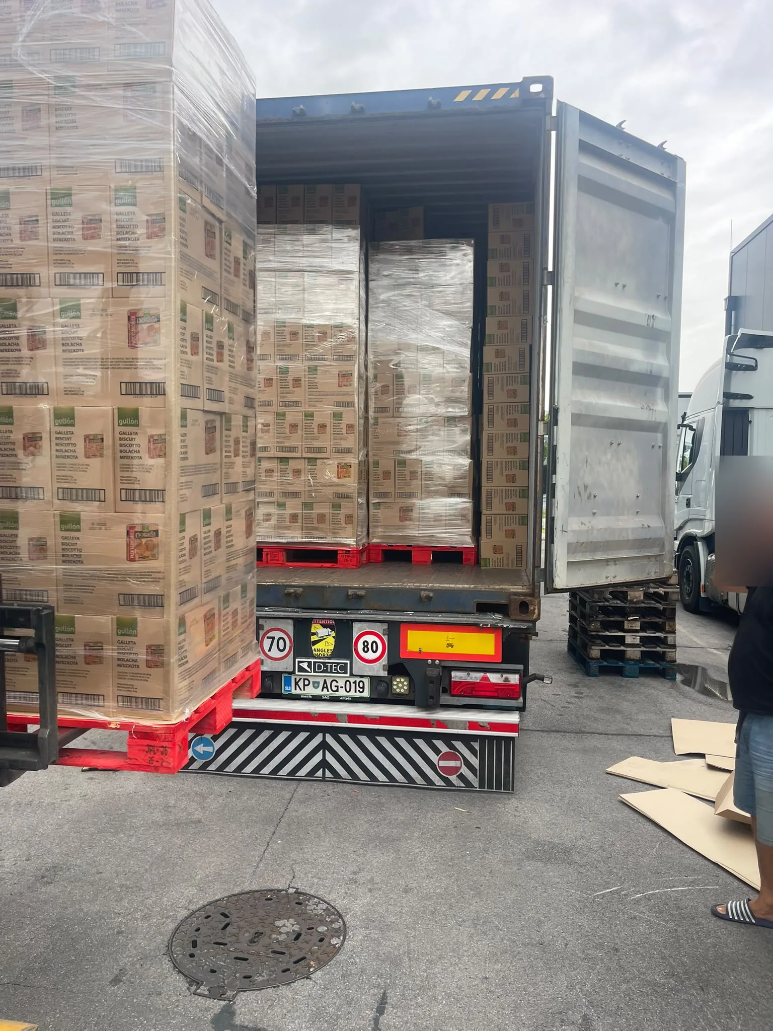 Palletised Gullón biscuits being loaded into a container